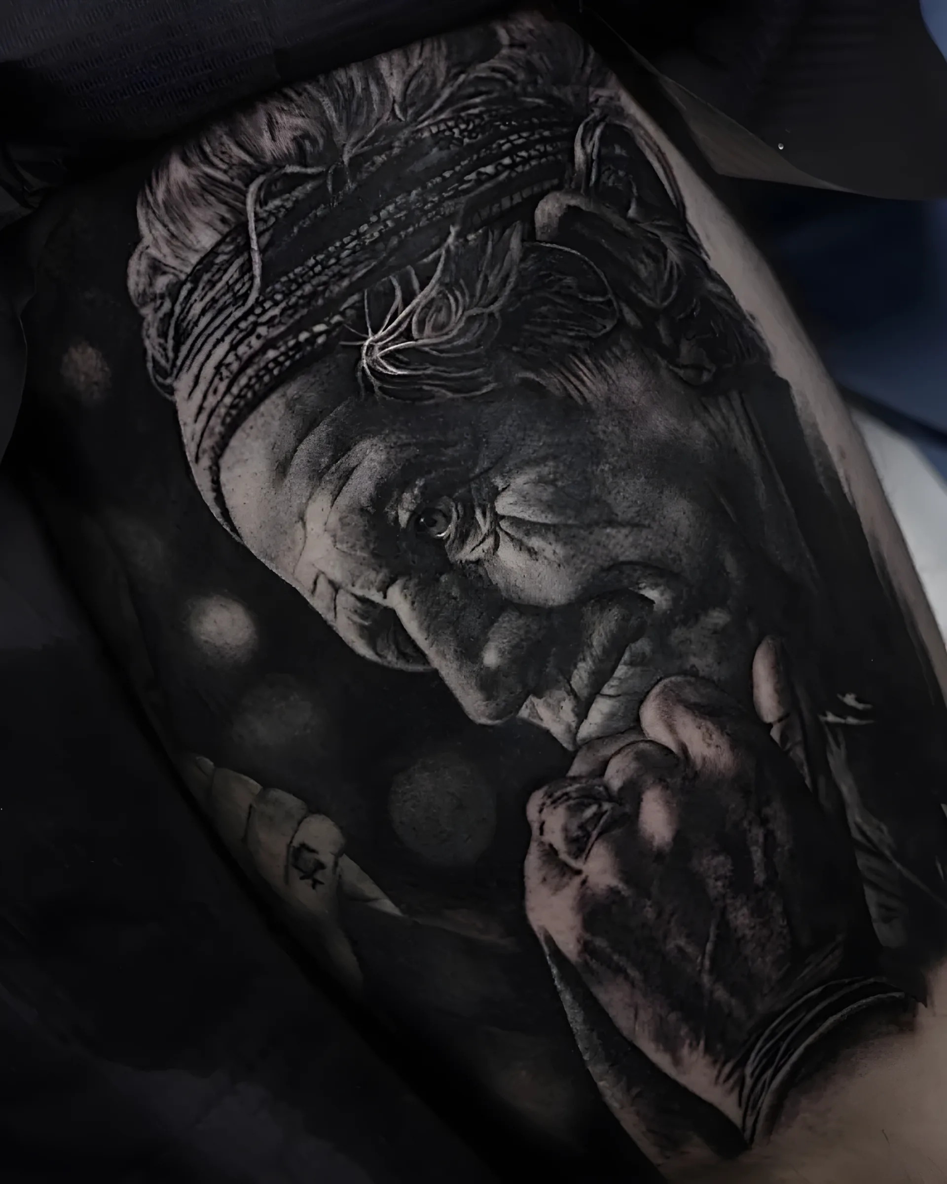 Hyper-realistic elder portrait tattoo in black and grey