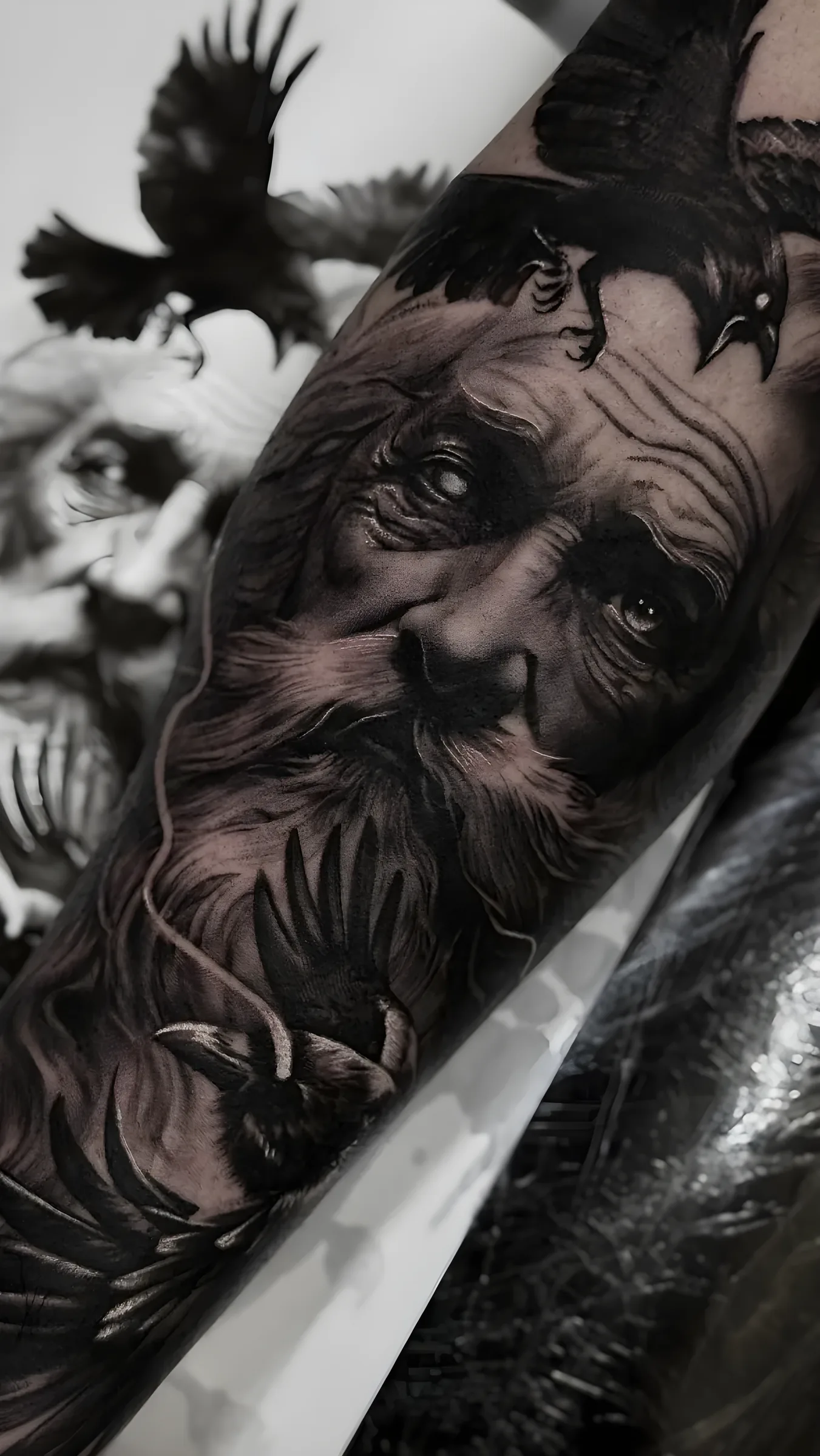 Man with raven realism tattoo