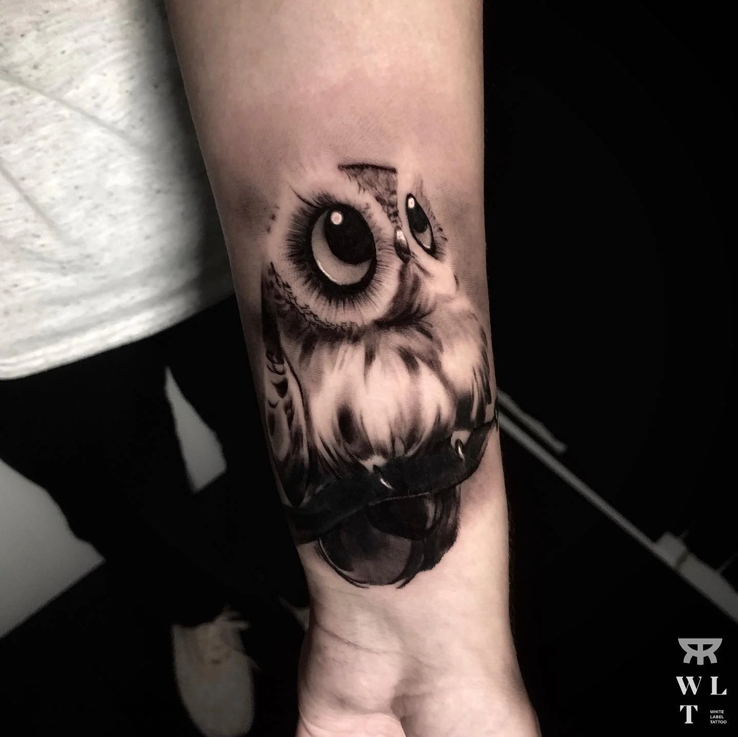 Black and grey cover up of an older tattoo on the arm