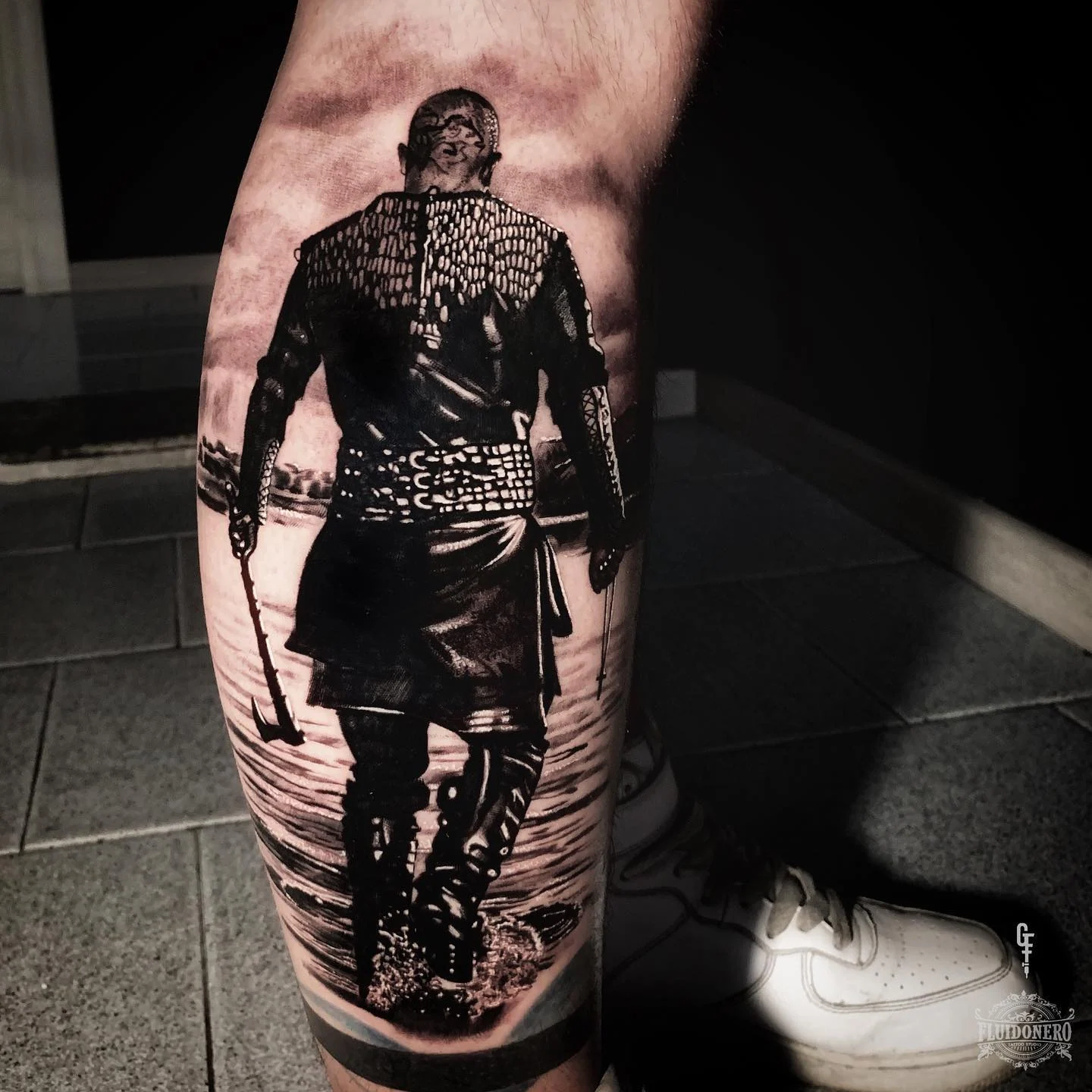Black and grey figure of Ragnar walking away, on the calf