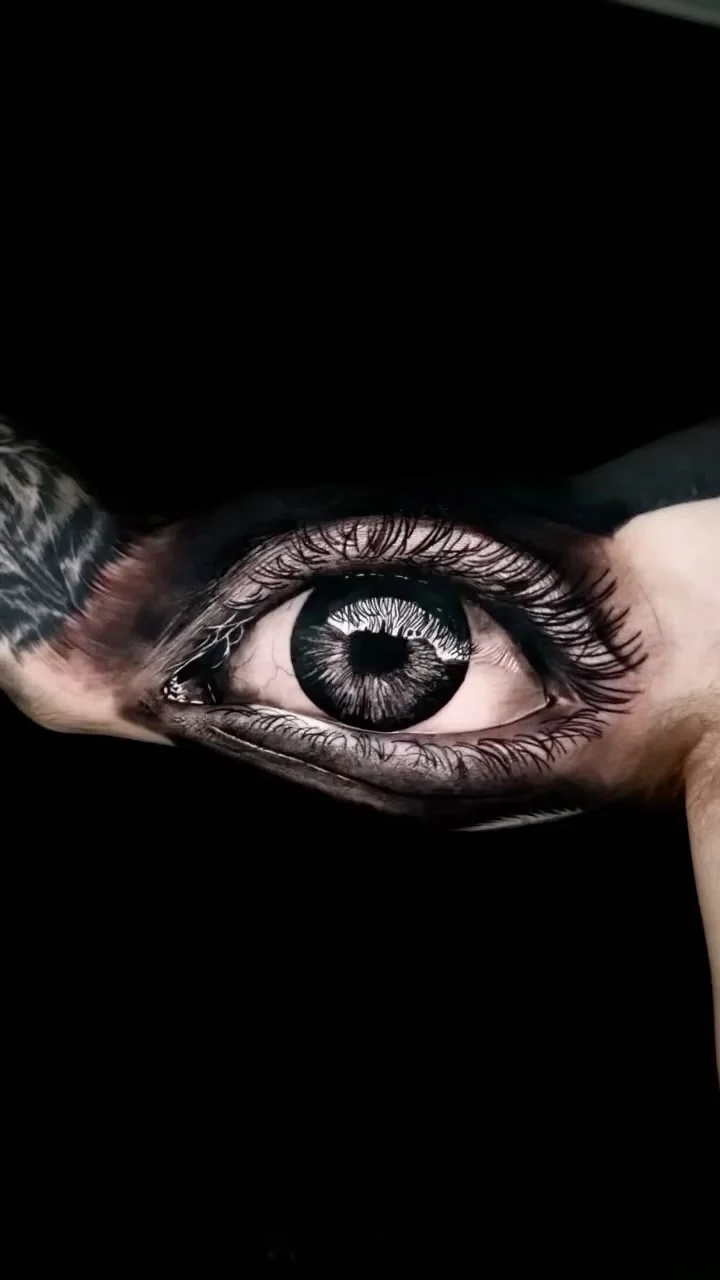 Hyper realistic black and grey eye tattoo