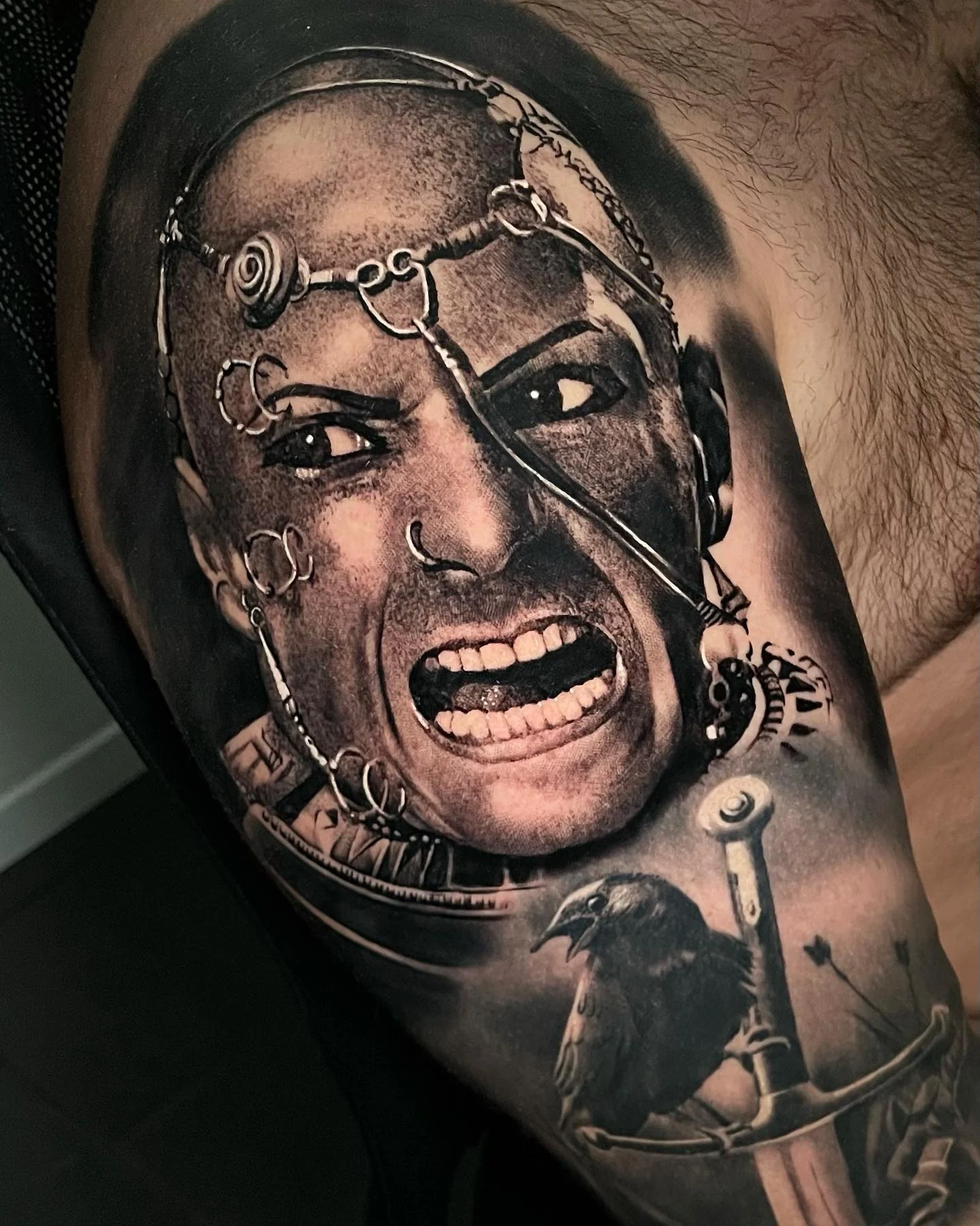 Black and grey warrior shouting, with a raven and a sword