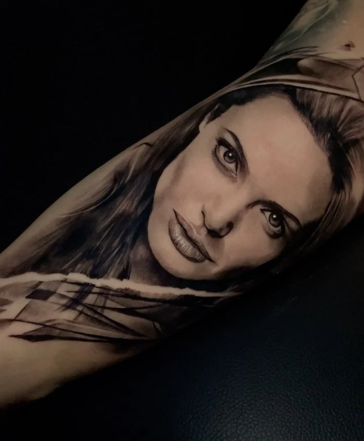 Healed black and grey portrait of a woman on the inner forearm